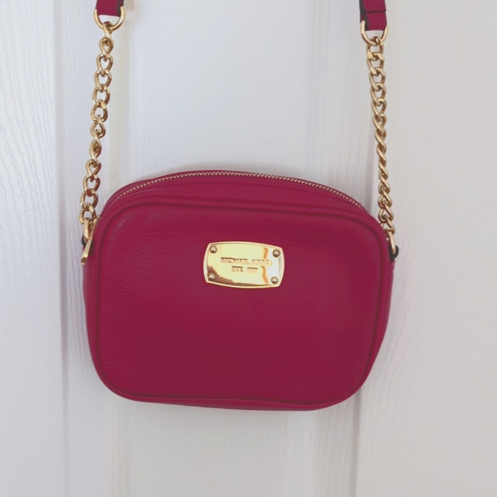 Michael Kors small pink crossbody with matching small wallet.